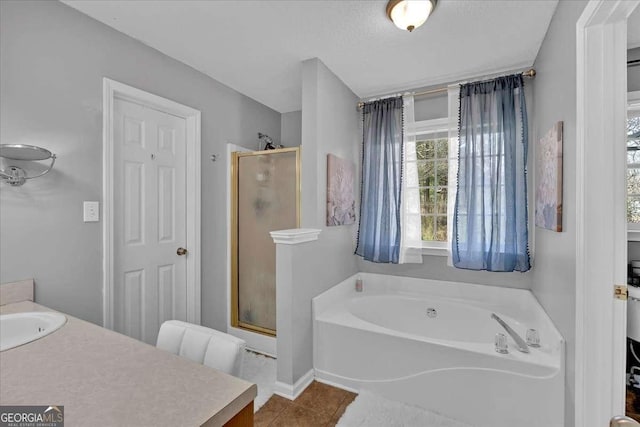 full bath with a bath, tile patterned flooring, a shower stall, and vanity