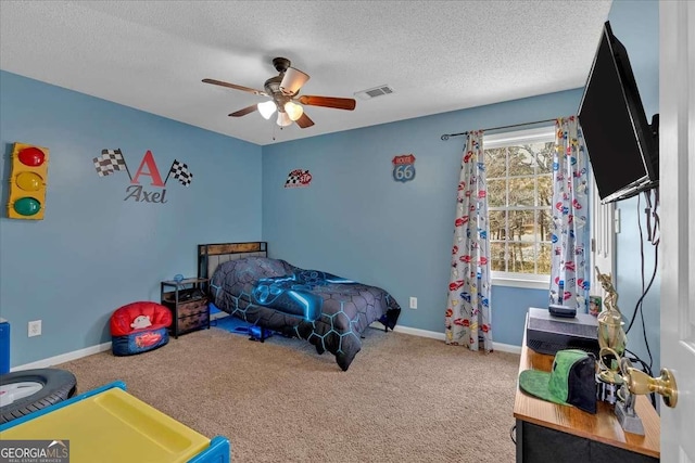 bedroom featuring carpet floors, visible vents, a textured ceiling, and baseboards