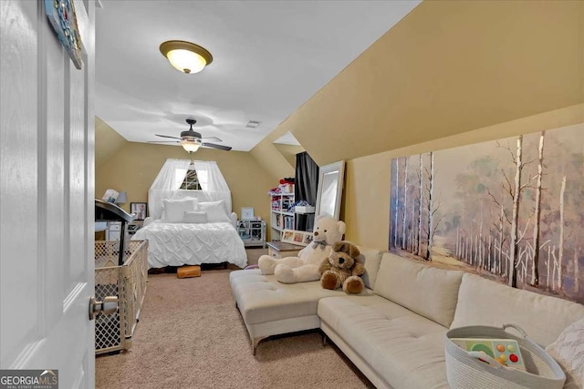 bedroom featuring lofted ceiling, a ceiling fan, visible vents, and carpet flooring