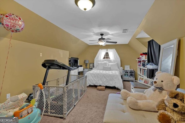 carpeted bedroom featuring lofted ceiling, visible vents, and a ceiling fan