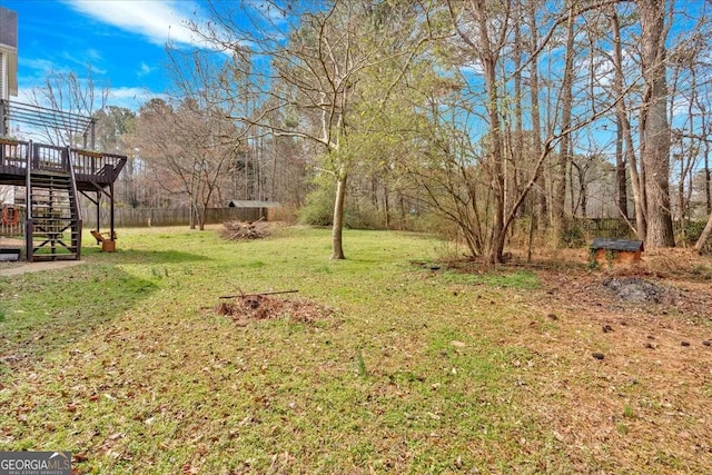 view of yard with stairway and a deck