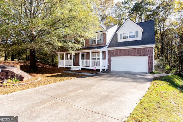 view of front of home with brick siding, a shingled roof, a porch, a garage, and driveway