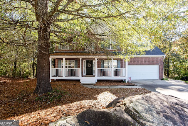 view of front of house with roof with shingles, a porch, an attached garage, concrete driveway, and brick siding