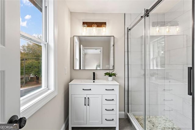 bathroom with a shower stall and vanity