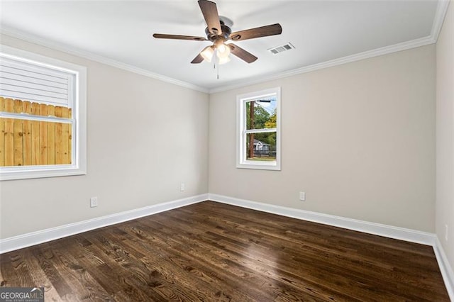 unfurnished room with dark wood-style flooring, visible vents, crown molding, and baseboards