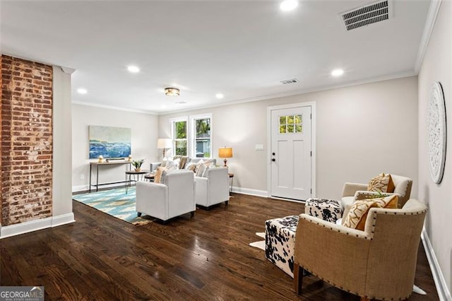 living room with ornamental molding, wood finished floors, visible vents, and baseboards