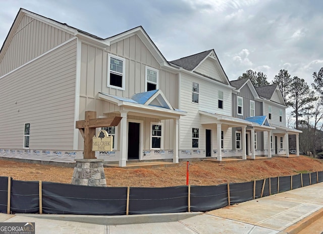 multi unit property featuring a porch and board and batten siding