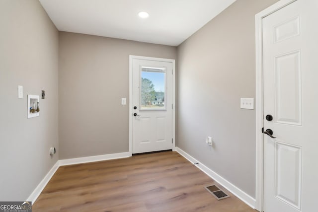 doorway featuring recessed lighting, baseboards, visible vents, and light wood finished floors