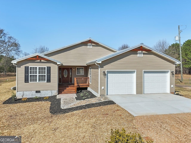 view of front of home with concrete driveway, covered porch, a garage, and crawl space