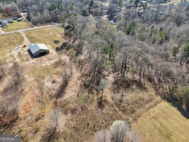 birds eye view of property with a forest view