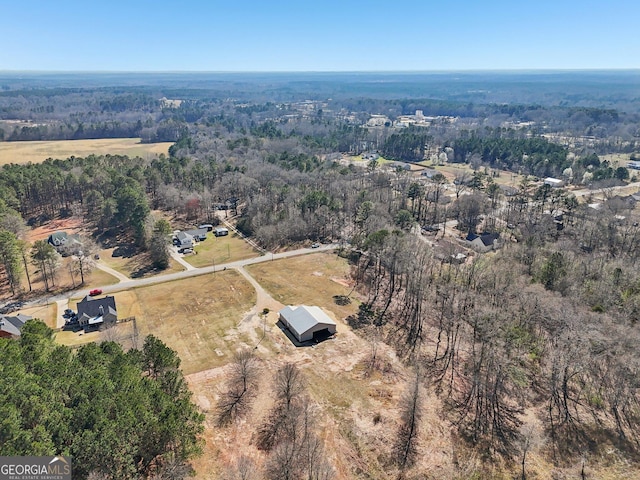 drone / aerial view with a wooded view