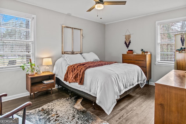 bedroom featuring crown molding, baseboards, ceiling fan, and wood finished floors