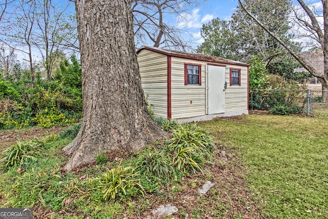 view of shed featuring fence