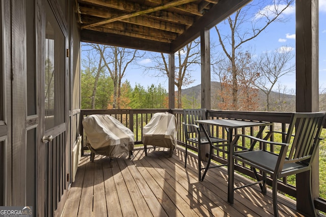 deck with a mountain view and area for grilling