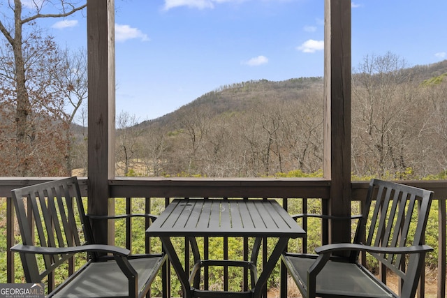 wooden deck featuring a mountain view and a view of trees