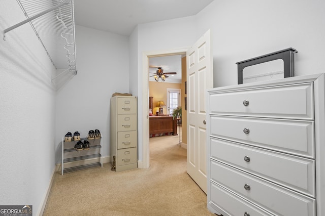 walk in closet featuring light carpet