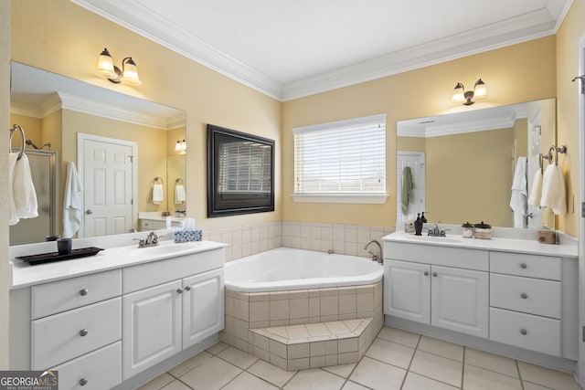 bathroom with two vanities, a sink, a bath, and crown molding