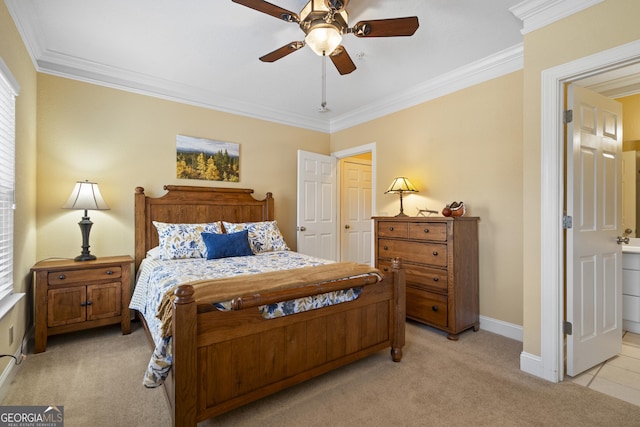 bedroom with ceiling fan, connected bathroom, light colored carpet, baseboards, and crown molding