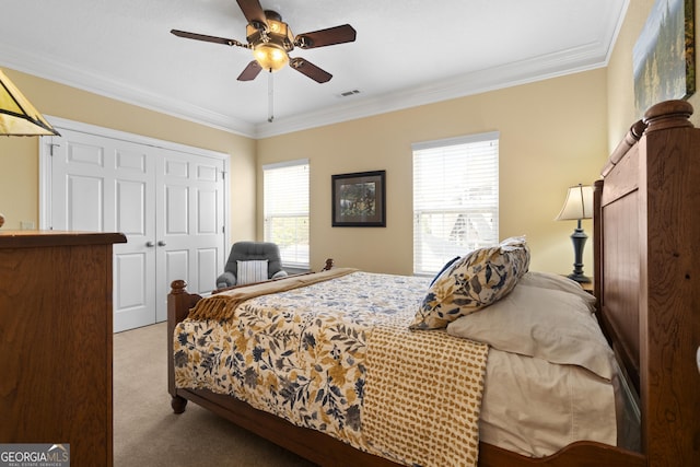 bedroom with visible vents, ceiling fan, ornamental molding, carpet flooring, and a closet