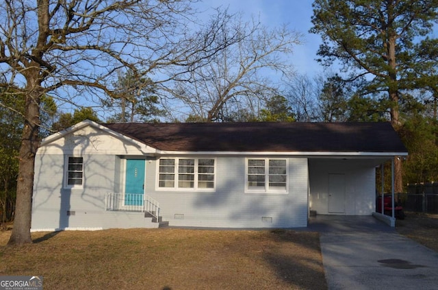 ranch-style home featuring crawl space, driveway, a front lawn, and brick siding