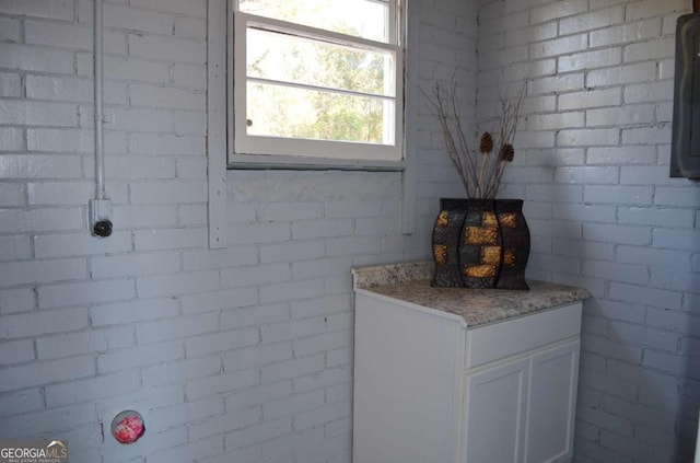 bathroom with brick wall