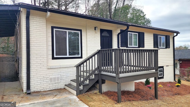 view of front facade featuring crawl space and brick siding