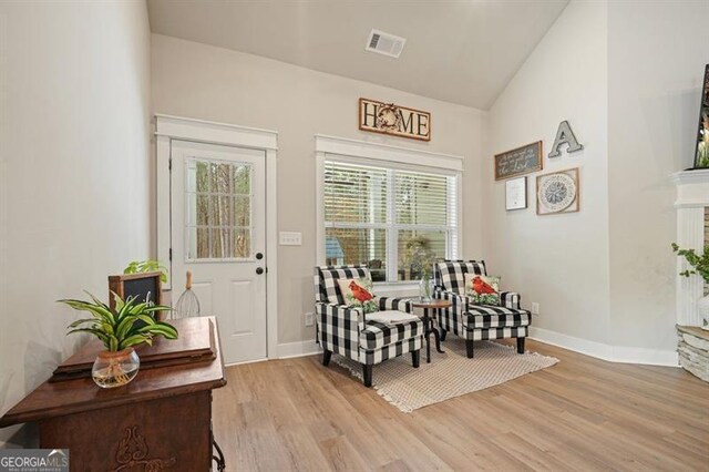 1312 Mcgarity Rd, Temple, GA 30179 - living area featuring light wood-style floors, baseboards, and high vaulted ceiling