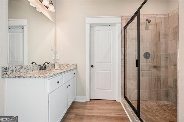 1312 Mcgarity Rd, Temple, GA 30179 - full bath featuring a shower stall, vanity, wood finished floors, and baseboards