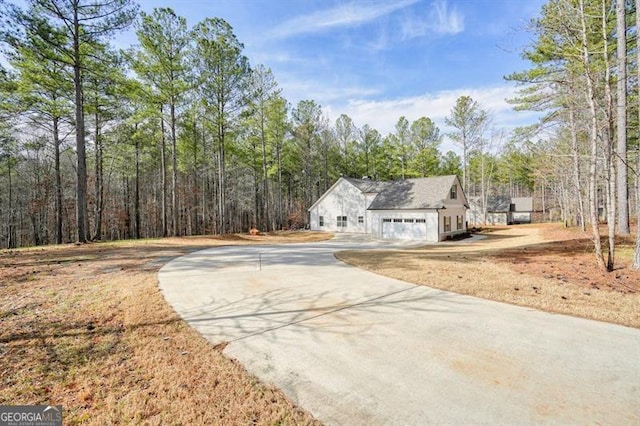 1312 Mcgarity Rd, Temple, GA 30179 - view of front of home featuring concrete driveway and a view of trees