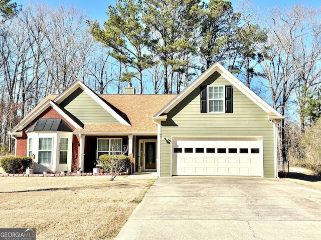 view of front of home with driveway, a shingled roof, a chimney, and brick siding