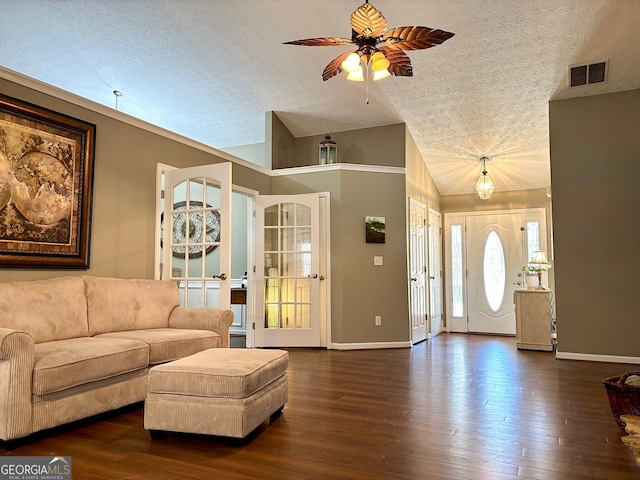 living room featuring lofted ceiling, a textured ceiling, dark wood-type flooring, visible vents, and baseboards