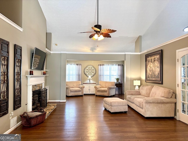 living room with a fireplace, dark wood finished floors, and baseboards