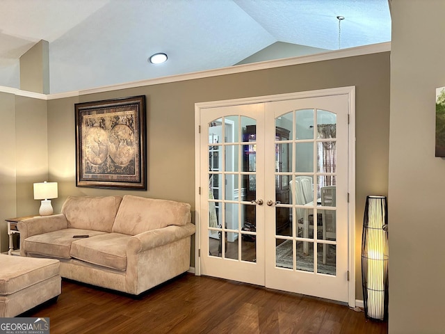 interior space with dark wood-style floors, french doors, vaulted ceiling, and ornamental molding