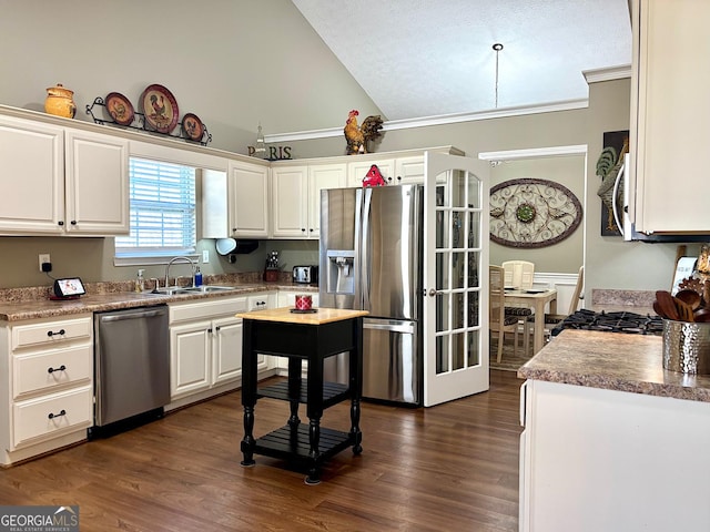 kitchen featuring dark wood finished floors, white cabinetry, stainless steel appliances, and a sink