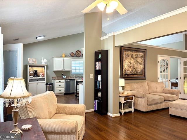 living room featuring ceiling fan, dark wood-type flooring, visible vents, baseboards, and vaulted ceiling