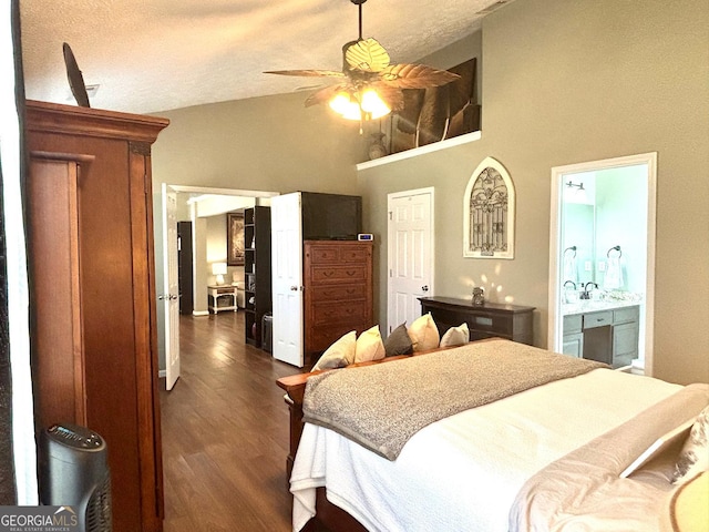 bedroom featuring ceiling fan, high vaulted ceiling, a textured ceiling, dark wood finished floors, and ensuite bath