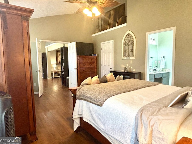 bedroom with vaulted ceiling, dark wood finished floors, a ceiling fan, and ensuite bathroom