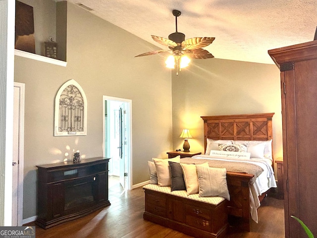 bedroom with visible vents, baseboards, dark wood-style floors, a textured ceiling, and high vaulted ceiling