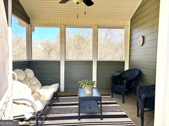 sunroom / solarium with lofted ceiling, wood ceiling, and ceiling fan