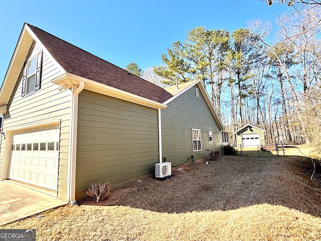 view of property exterior featuring a garage, driveway, and roof with shingles