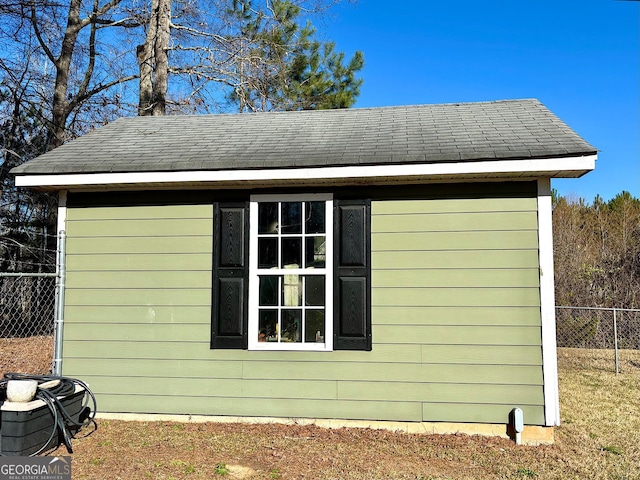 view of outbuilding featuring an outbuilding and fence