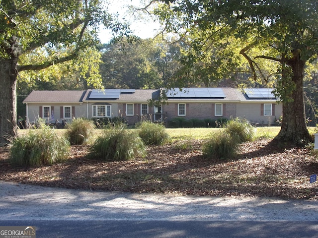 ranch-style house with solar panels