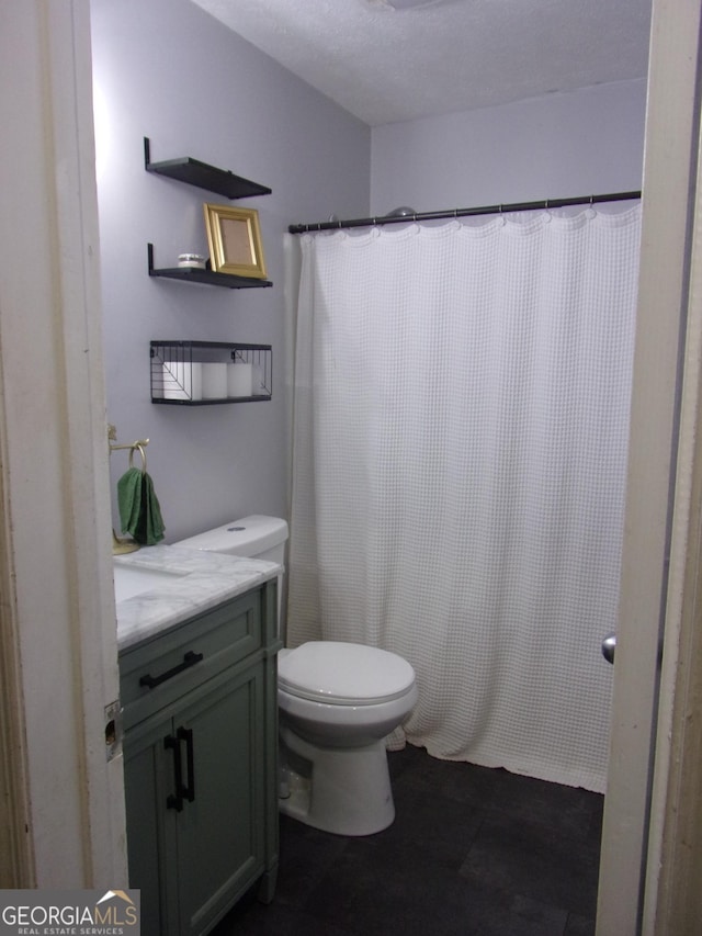 bathroom with a shower with curtain, vanity, and toilet