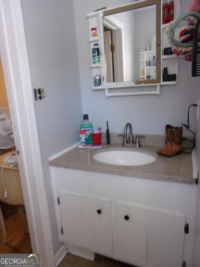 bathroom featuring vanity and wood finished floors