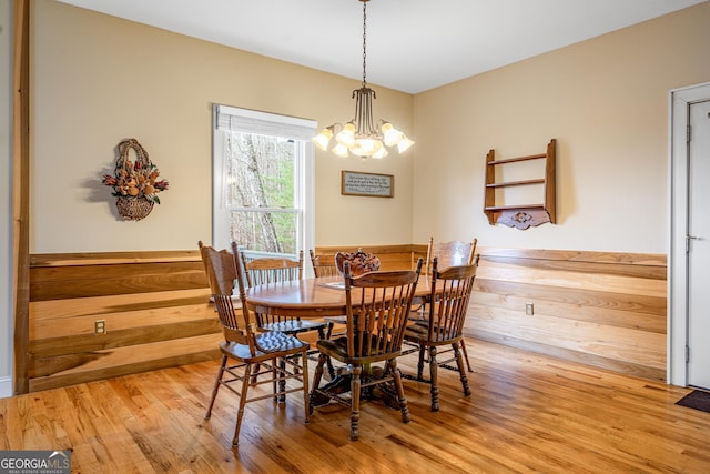 dining room with a notable chandelier and wood finished floors