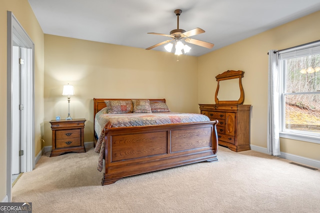 bedroom featuring a ceiling fan, baseboards, visible vents, and carpet flooring