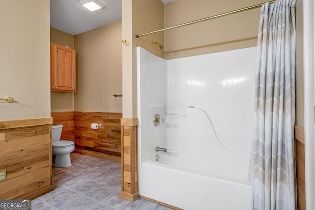 bathroom featuring shower / tub combo with curtain, toilet, and tile patterned floors