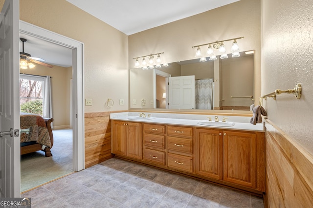 full bathroom with double vanity, connected bathroom, a ceiling fan, and a sink