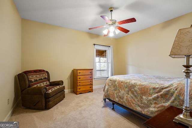 carpeted bedroom with ceiling fan and baseboards