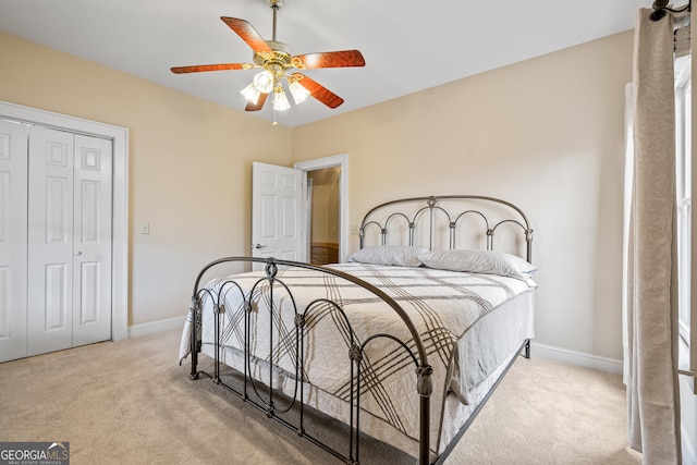 bedroom with ceiling fan, a closet, carpet, and baseboards